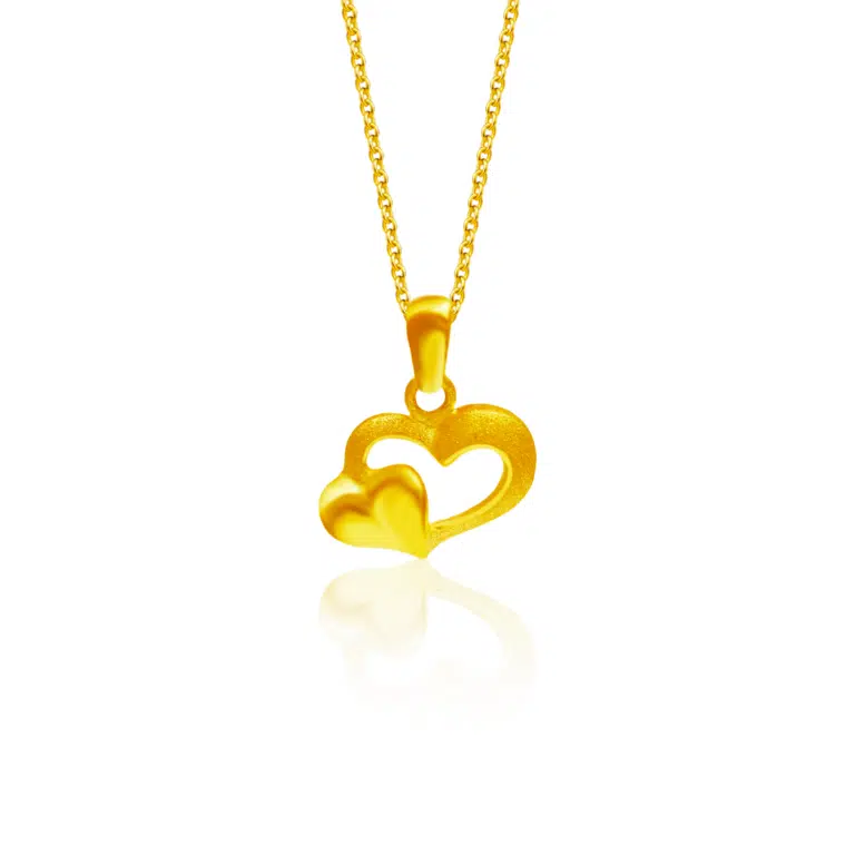 SK heart necklace in 999 gold material featuring a unique nested heart design with a glittering textured finish beautifully framing a smaller polished heart within