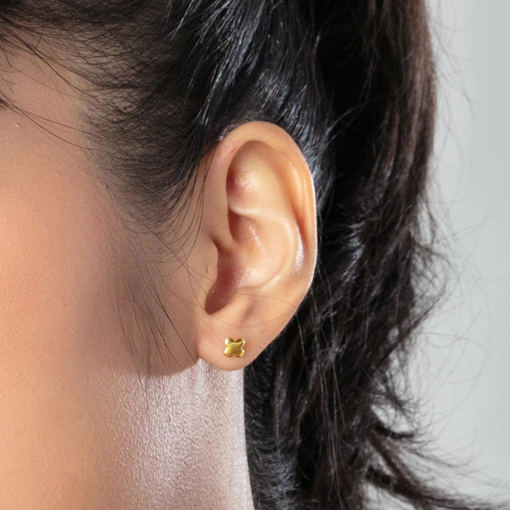 women wearing SK 916 Dainty Clover Gold Stud Earrings in yellow gold, featuring a smooth clover-shaped design crafted from 916 gold