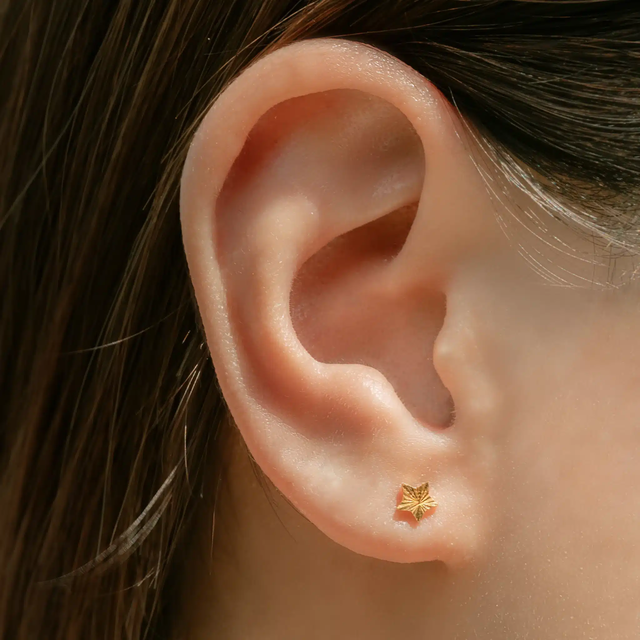 Women wearing SK 916 Frilled Star Gold Stud Earrings made from 916 yellow gold