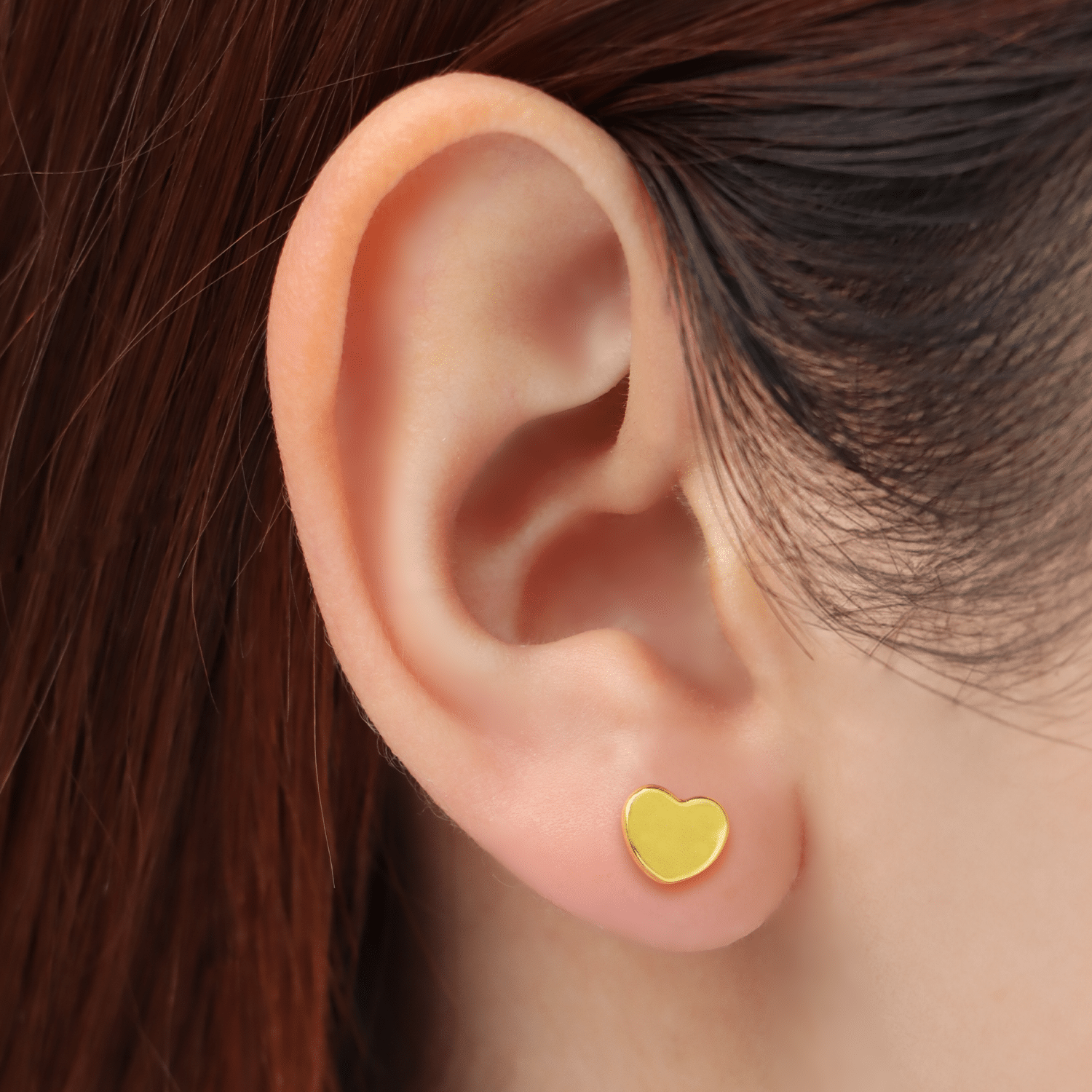 women wearing Classic Heart 916 Gold Stud Earrings featuring a smooth, polished heart-shaped design made from 916 yellow gold 